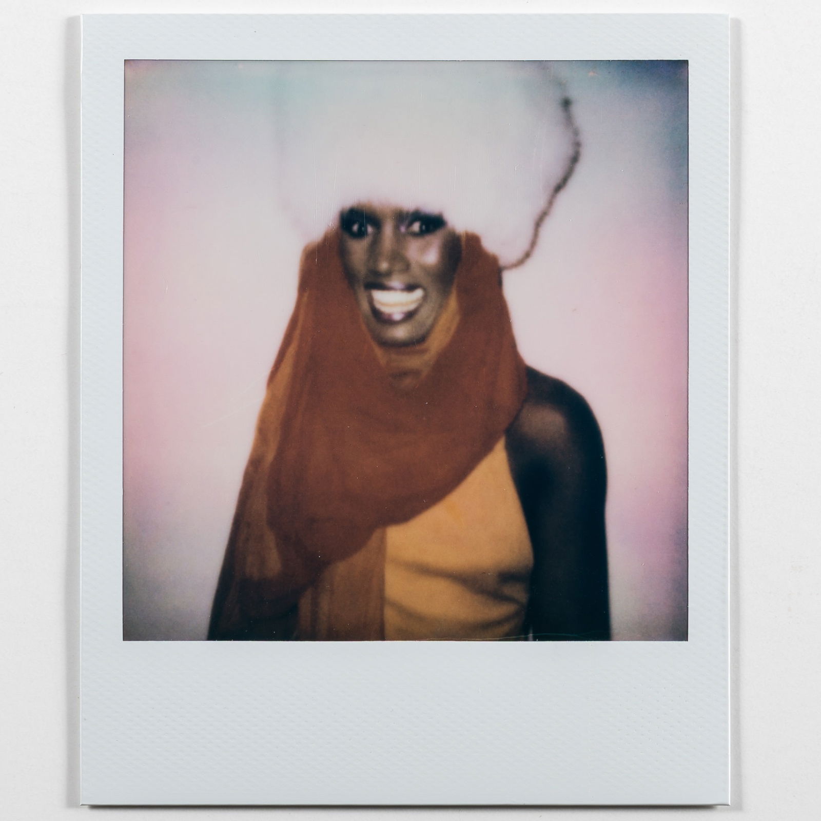 Andy Warhol Grace Jones in Red Scarf, 1984: WARHOL, ANDY (1928–1987) [Grace Jones in Red Scarf, 1984]. Unique Polaroid print, image 3 x 3 inches (76 x 76 mm), overall 4 1/4 x 3 1/2 inches (108 x 88 mm), the verso with The Estate of Andy W