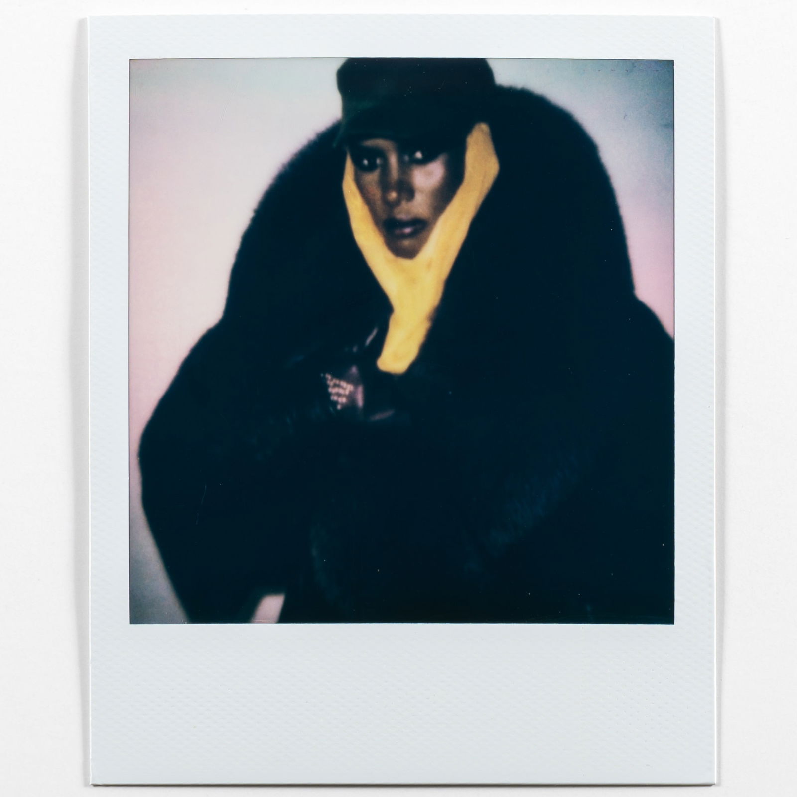 Andy Warhol, Grace Jones in Black Coat, 1984: WARHOL, ANDY (1928–1987) [Grace Jones in Black Coat, 1984]. Unique Polaroid print, image 3 x 3 inches (76 x 76 mm), overall 4 1/4 x 3 1/2 inches (108 x 88 mm), the verso with The Estate of Andy