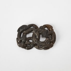 A Chinese Black and Celadon Jade Dragon-Form Pendant Ming Dynasty