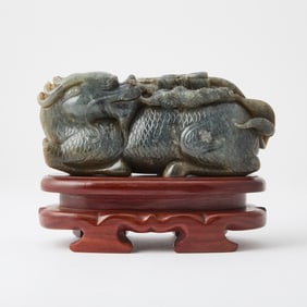 A Chinese Mottled Jade Figural Carving of a Qilin