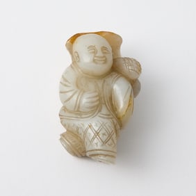 A Chinese White Jade Figural Carving of a Boy Qing Dynasty or Earlier