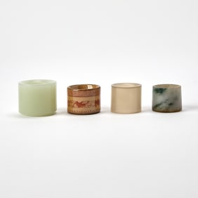Four Chinese Hardstone and Porcelain Thumb Rings Qing Dynasty
