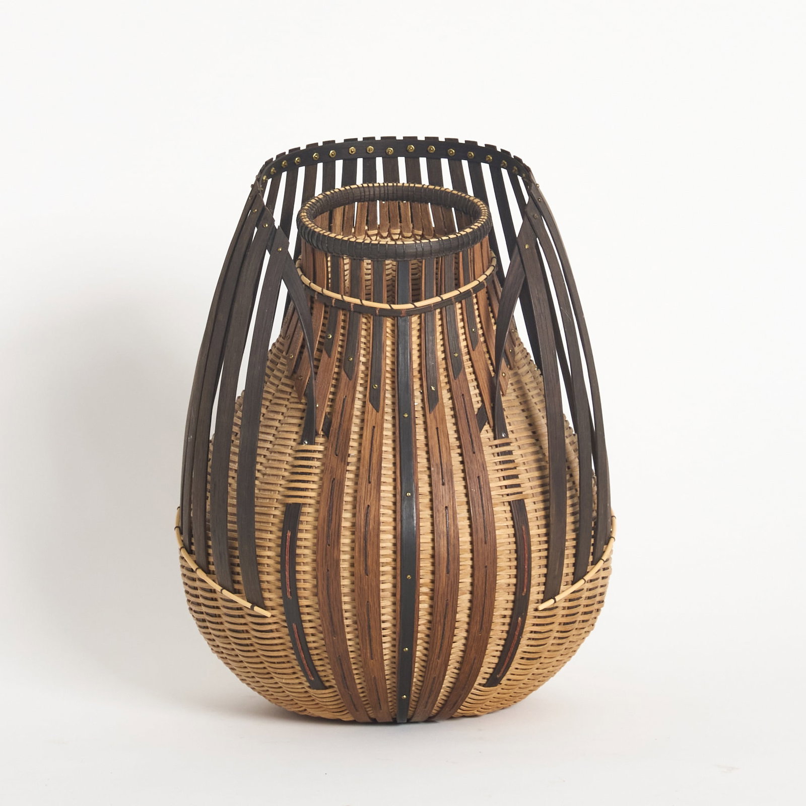 Leon Niehues Various Woods Free-Form Basket: Likely made with white oak and walnut, unsigned. Height 12 1/2 inches. Generally good condition with no apparent damage.