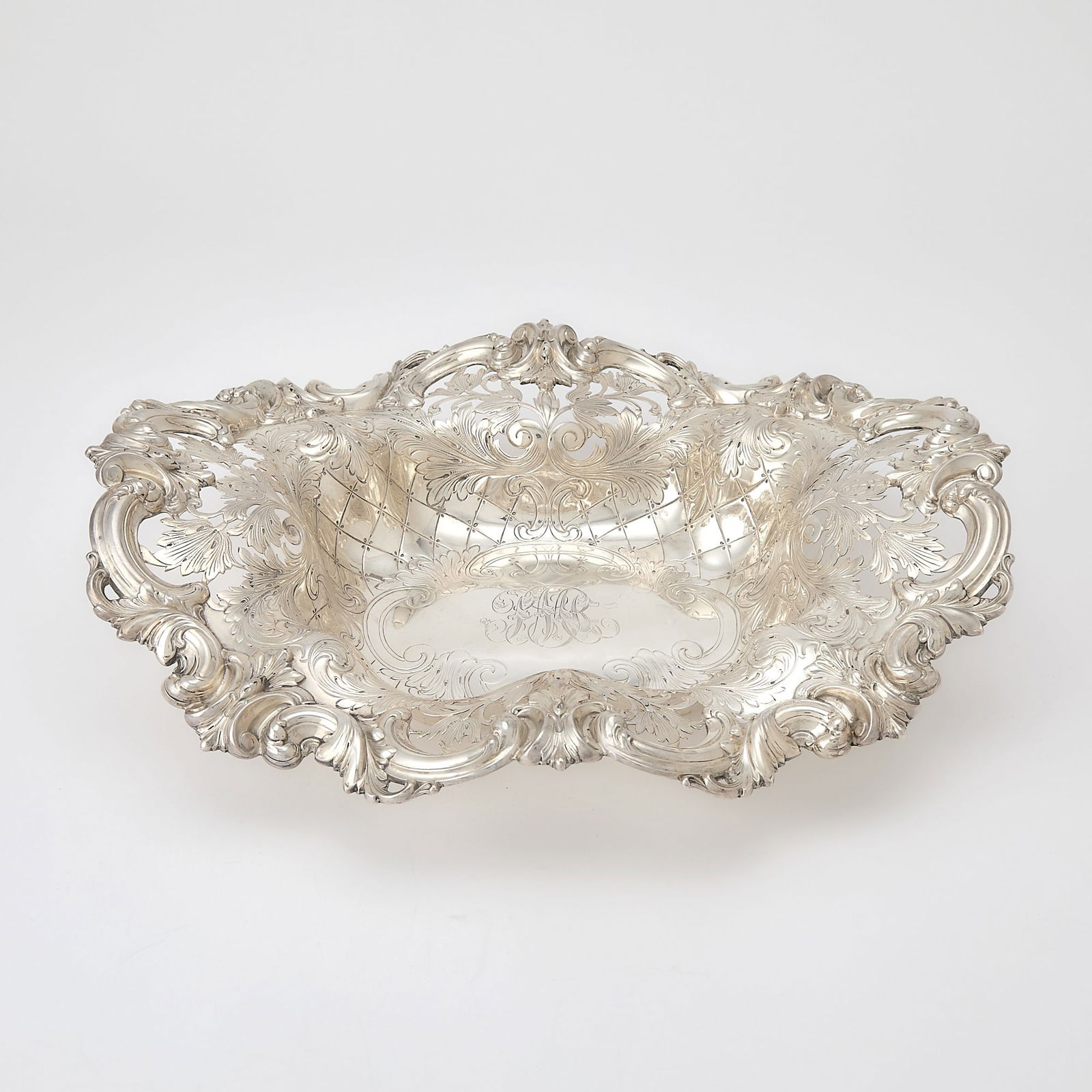 Frank Smith Silver Co. Sterling Silver Centerpiece Basket: Retailed by Berry & Whitmore Co., early 20th century Shaped oval, border with applied foliate scrolls and pierced foliate panels, the body engraved with foliage and lattice. Length 14 1/2 inches,