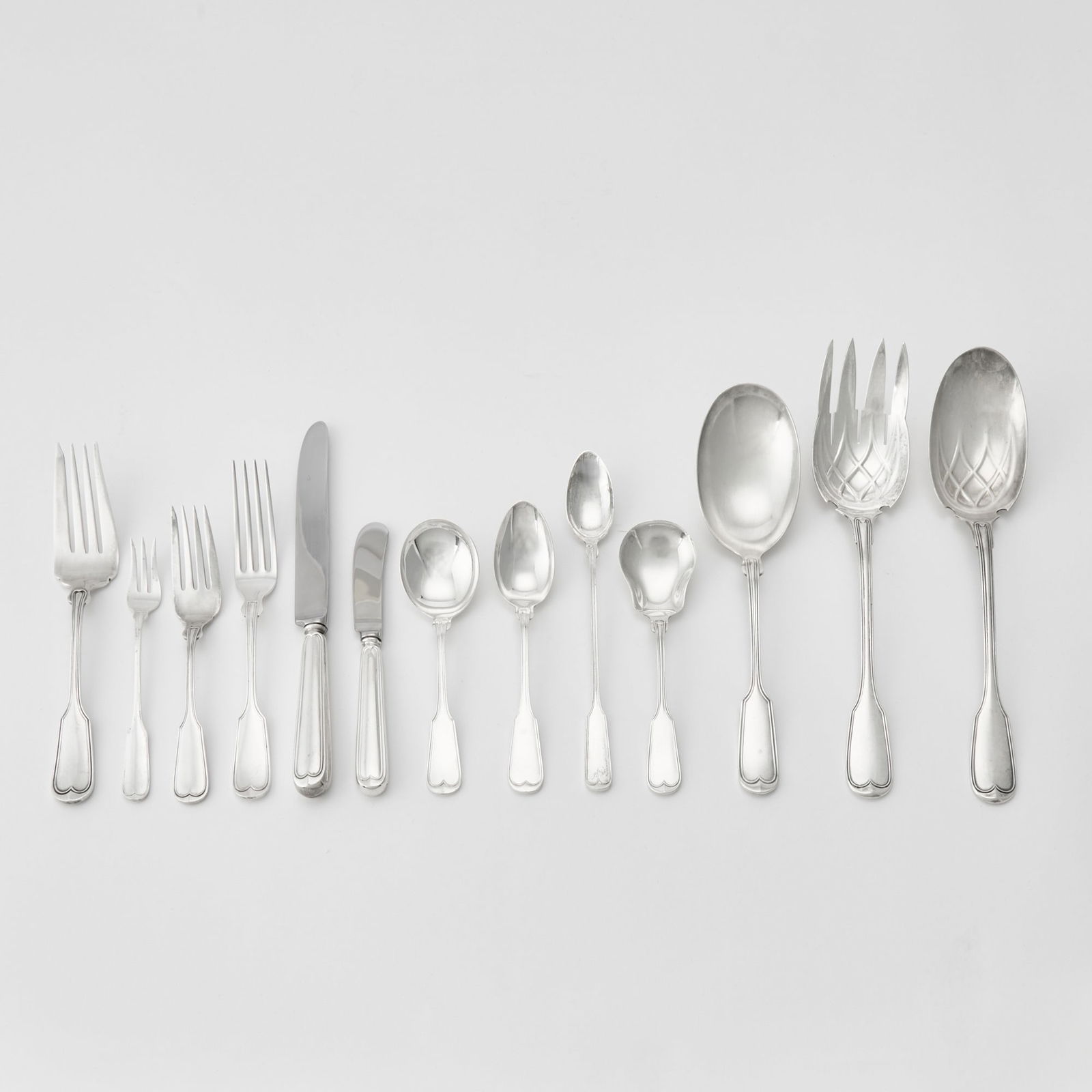 Frank Smith Sterling Silver "Fiddle Thread" Pattern Flatware Service: 20th Century Comprising: Twelve dinner forksTwelve salad forksTwelve cocktail forksEleven dinner knivesTwelve butter knivesEleven bouillon spoonsSix iced tea spoonsEleven teaspoonsPair of