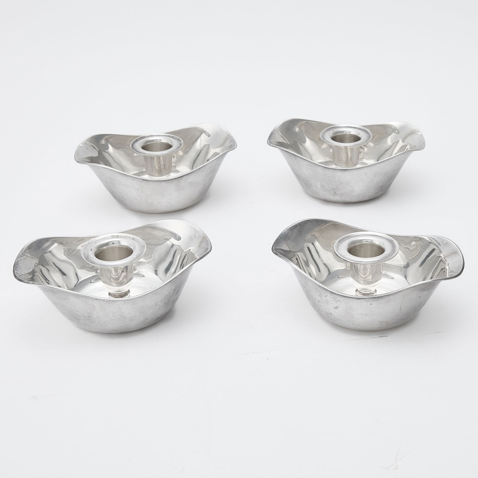 Set of Four Danish Sterling Silver Candleholders: Erik Herlow for A. Michelsen, Copenhagen, mid 20th century Length 5 1/2 inches, total approximately 20 ounces. Generally good condition overall