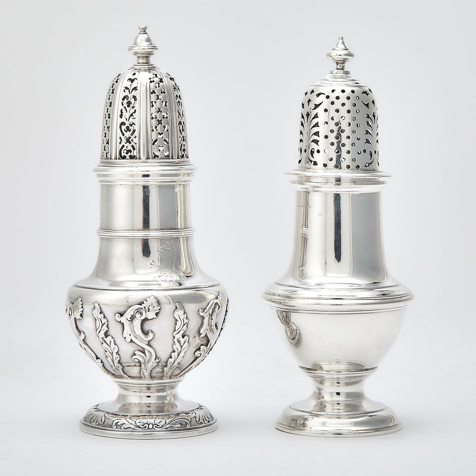 George I Sterling Silver Sugar Caster: George Wickes, London, 1730s Typical form, the body with applied strapwork, the domed cover with pierced panels and acorn-form finial, height 7 1/2 inches (19 cm); Together with a Crichton & Co. S