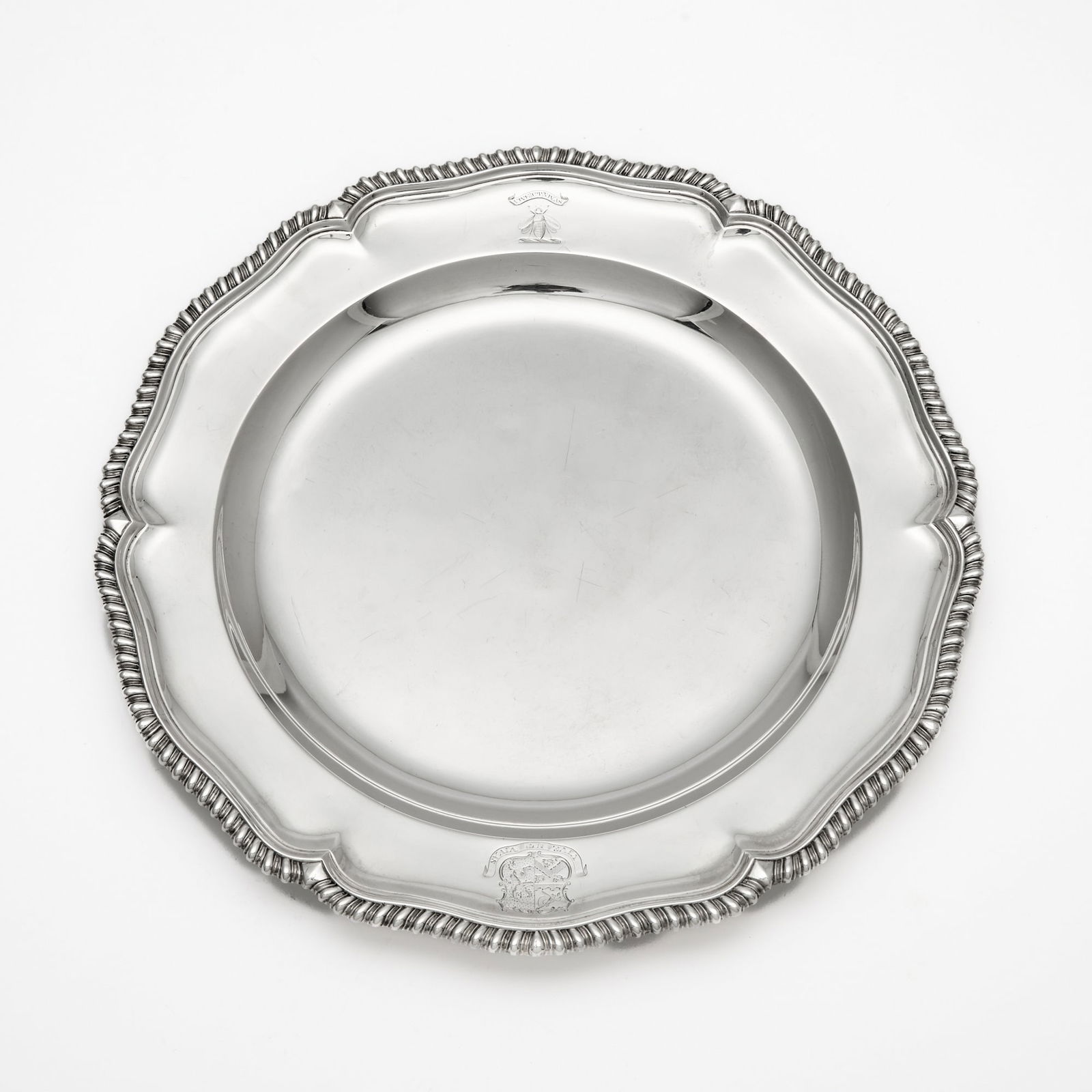 George III Sterling Silver Second Course Plate: Alexander Johnston, London, 1759 Shaped circular with gadrooned border. Diameter 11 1/4 inches (28.4 cm), approximately 22 ounces. Generally good condition overall with light wear and marking from no