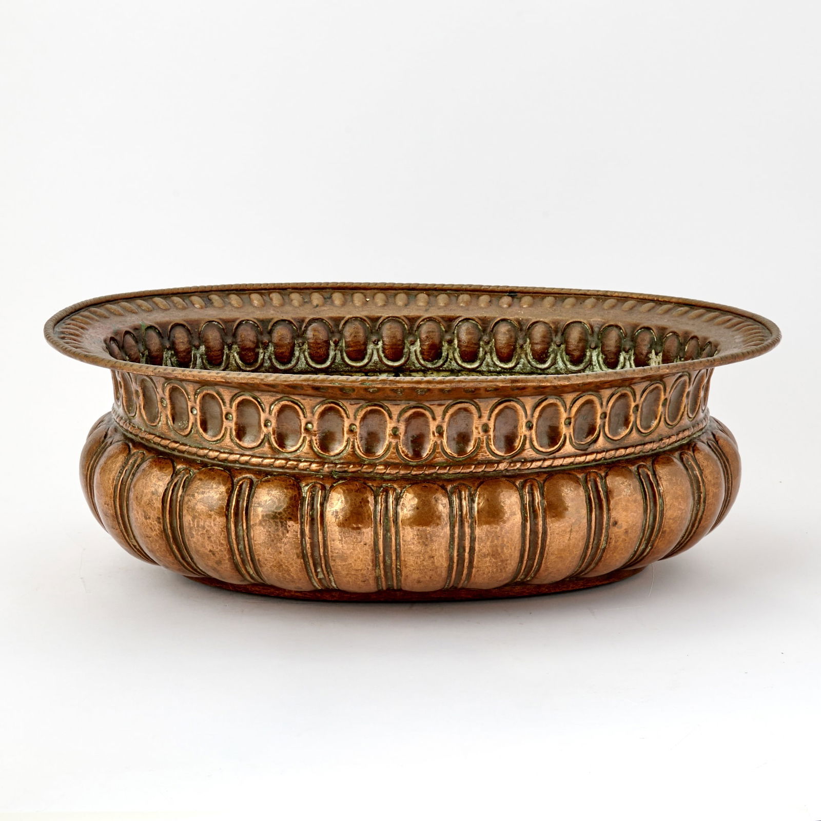 North Italian Baroque Oval Copper Wine Cooler: Probably Venetian, 17th Century With flaring rim and beaded border above a band of repeating ovolo ornament, the lower body with deep lobed gadrooning in repouse relief. Height 7 1/4 inches (18.5 cm),