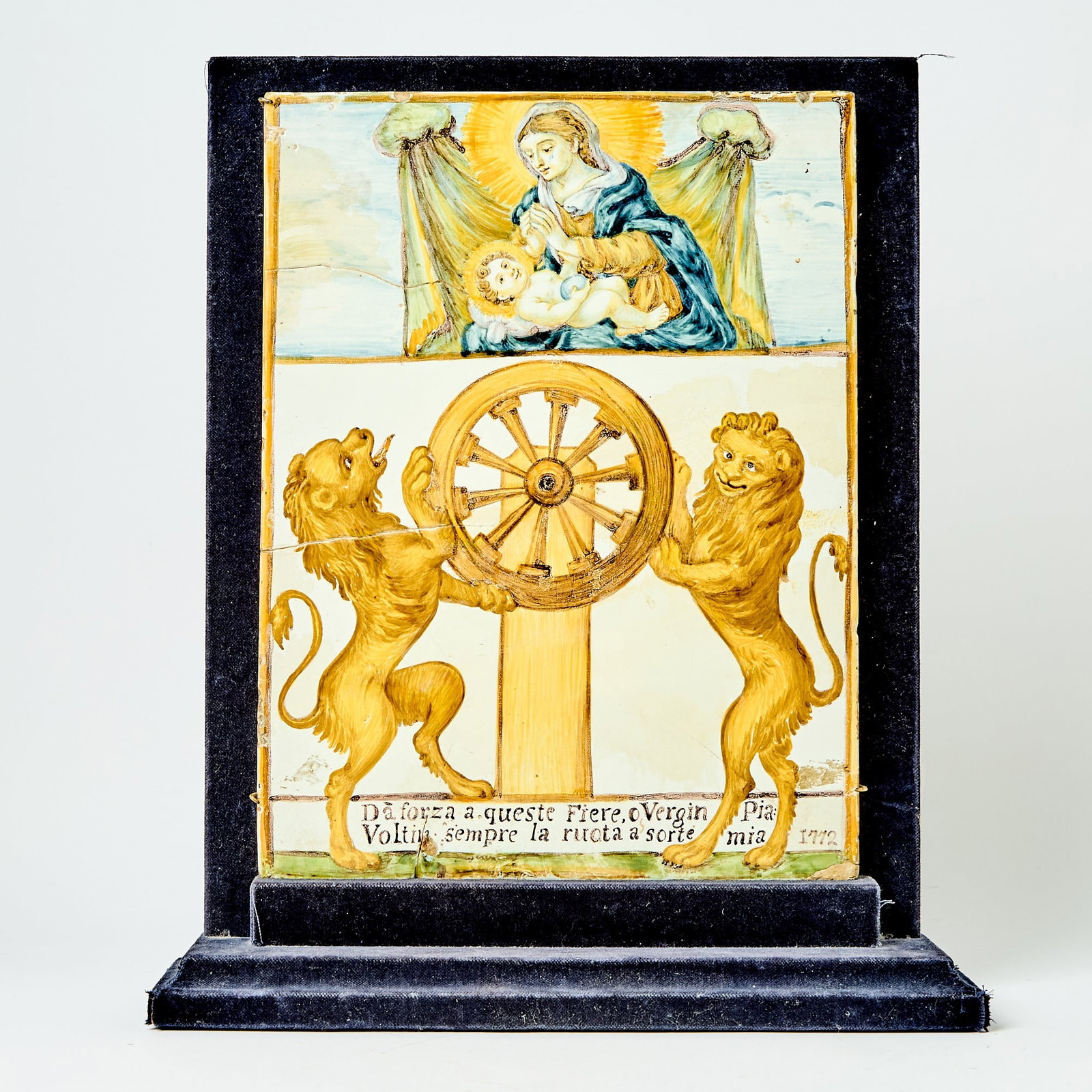 Castelli Maiolica Plaque: Circa 1772 Painted with the Virgin and Child above two rearing lions on either side of a wheel in blue, yellow ochre, and manganese, inscribed Dà forza a queste Fiere o Vergin Pia / Voltin sempre