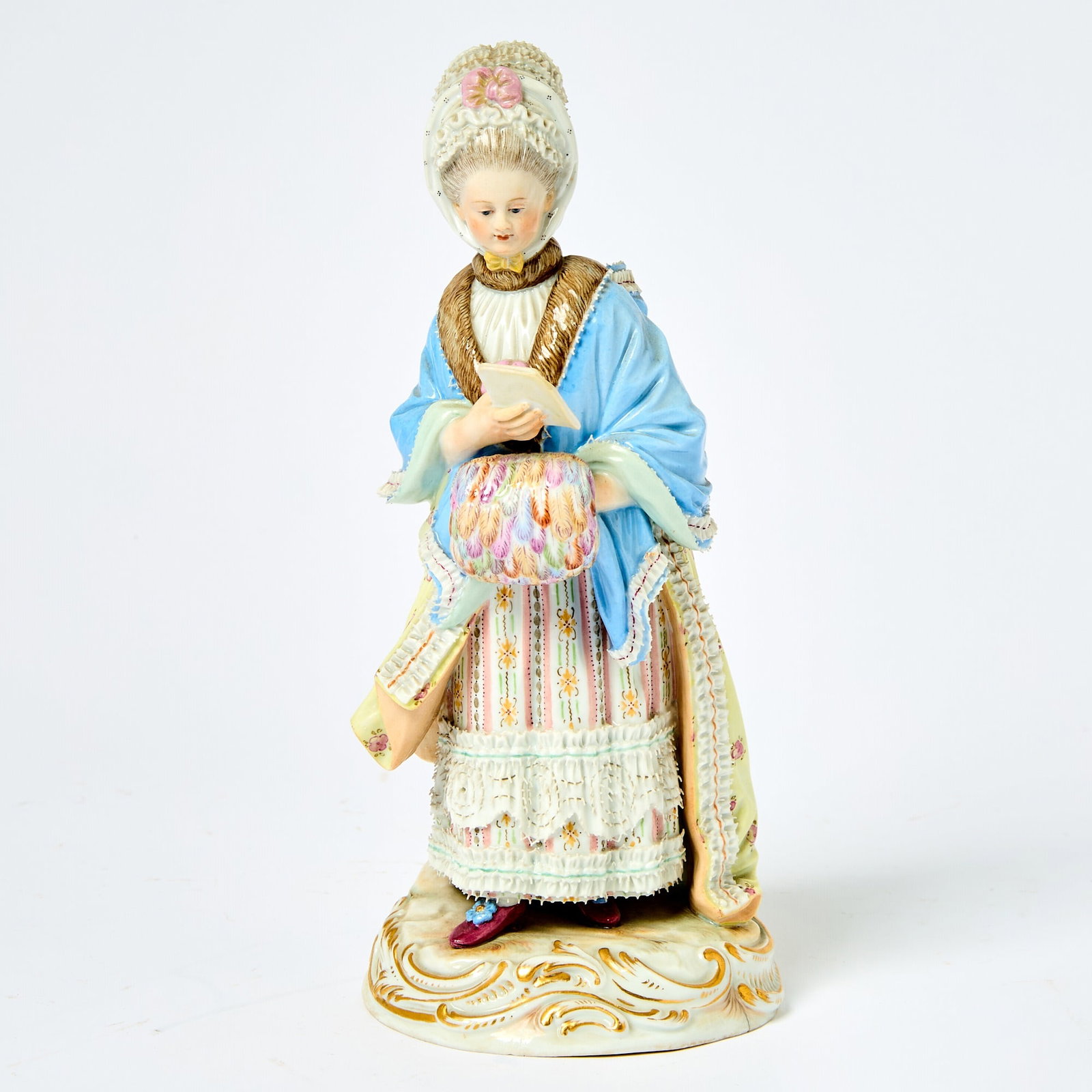 Meissen Porcelain Figure of a Lady with a Muff: After a model by Michel Victor Acier and J.C. Schonheit, 19th century Realistically modeled reading a letter, her left hand holding a feather muff of various colors, her bonnet, fur-lined cloak, and f