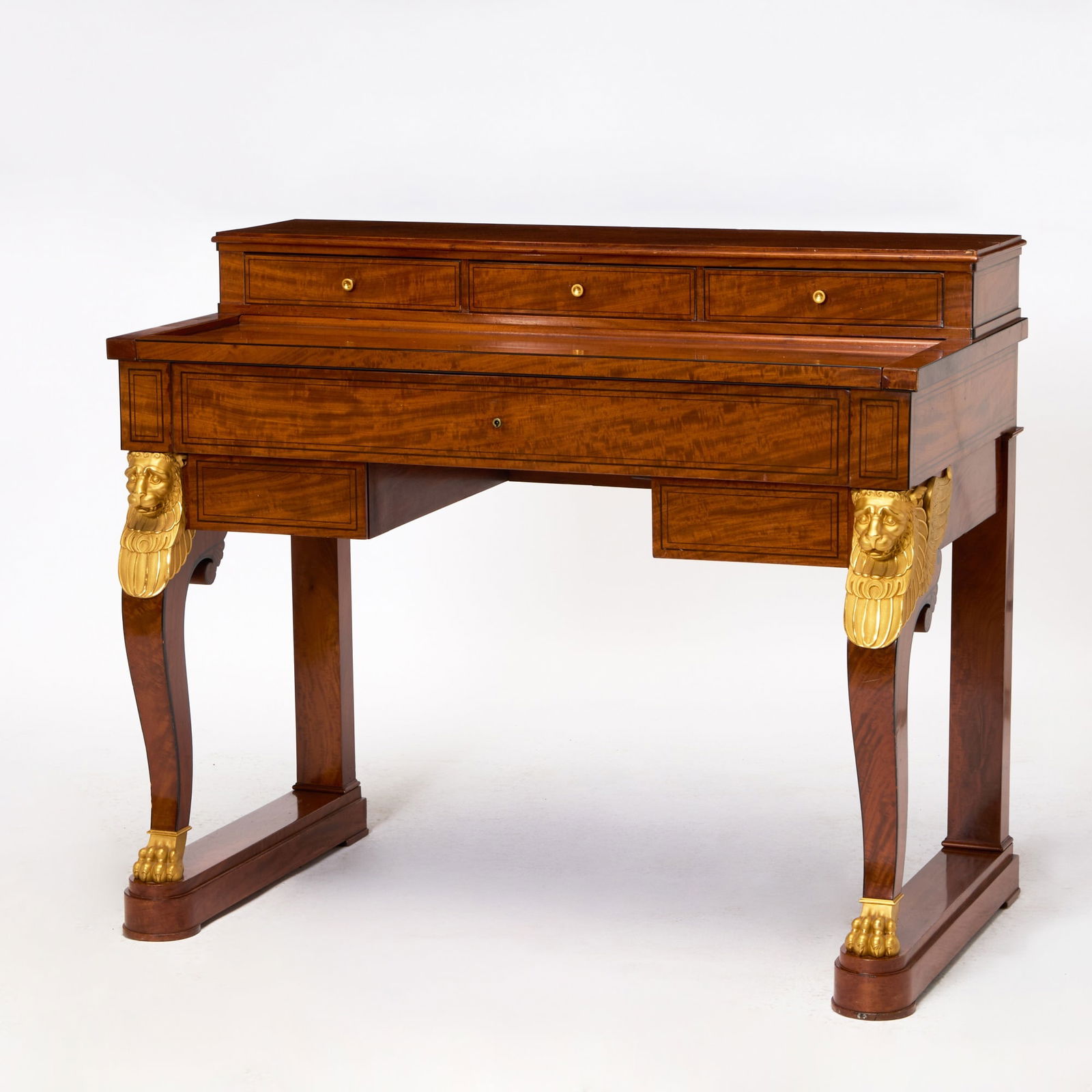 Empire Ormolu-Mounted Mahogany Desk: Attributed to Jacob Frères, Rue Meslée, circa 1800 The rectangular top section with three frieze drawers above a slide opening to reveal a sliding red tooled leather-lined writing surface an