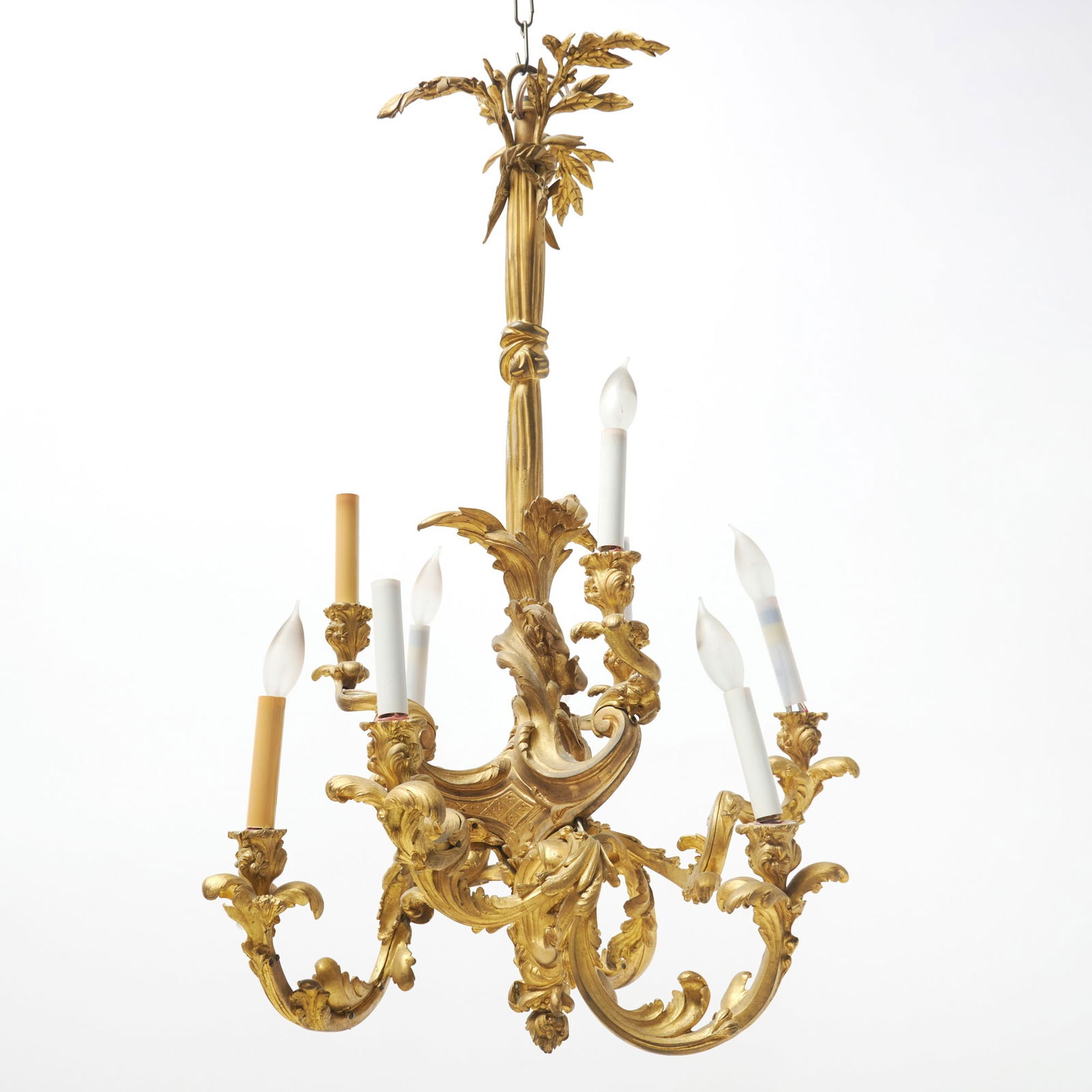 Louis XV Style Gilt-Bronze Six-Light Chandelier: Late 19th century The tied stem issuing two tiers of sweeping acanthus-cast candle arms, with berry and blossom finial. Height 32 inches (81 cm), diameter 22 inches (55.8 cm). Lacking one screw to
