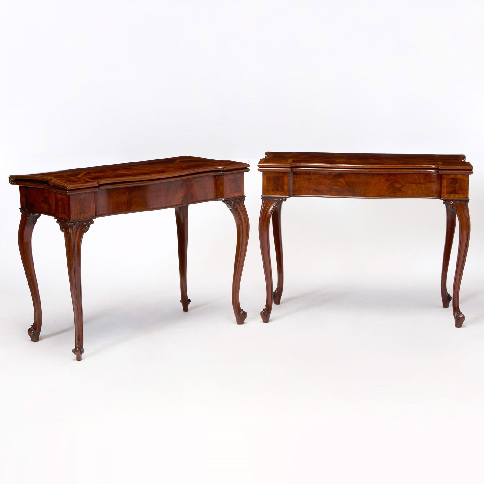 Pair of George III Mahogany Card Tables: In the manner of Thomas Chippendale, circa 1760 Each hinged, shaped serpentine top with astragal parquetry inlay opening to a later gilt-tooled green leather-lined interior, above a conforming frieze,