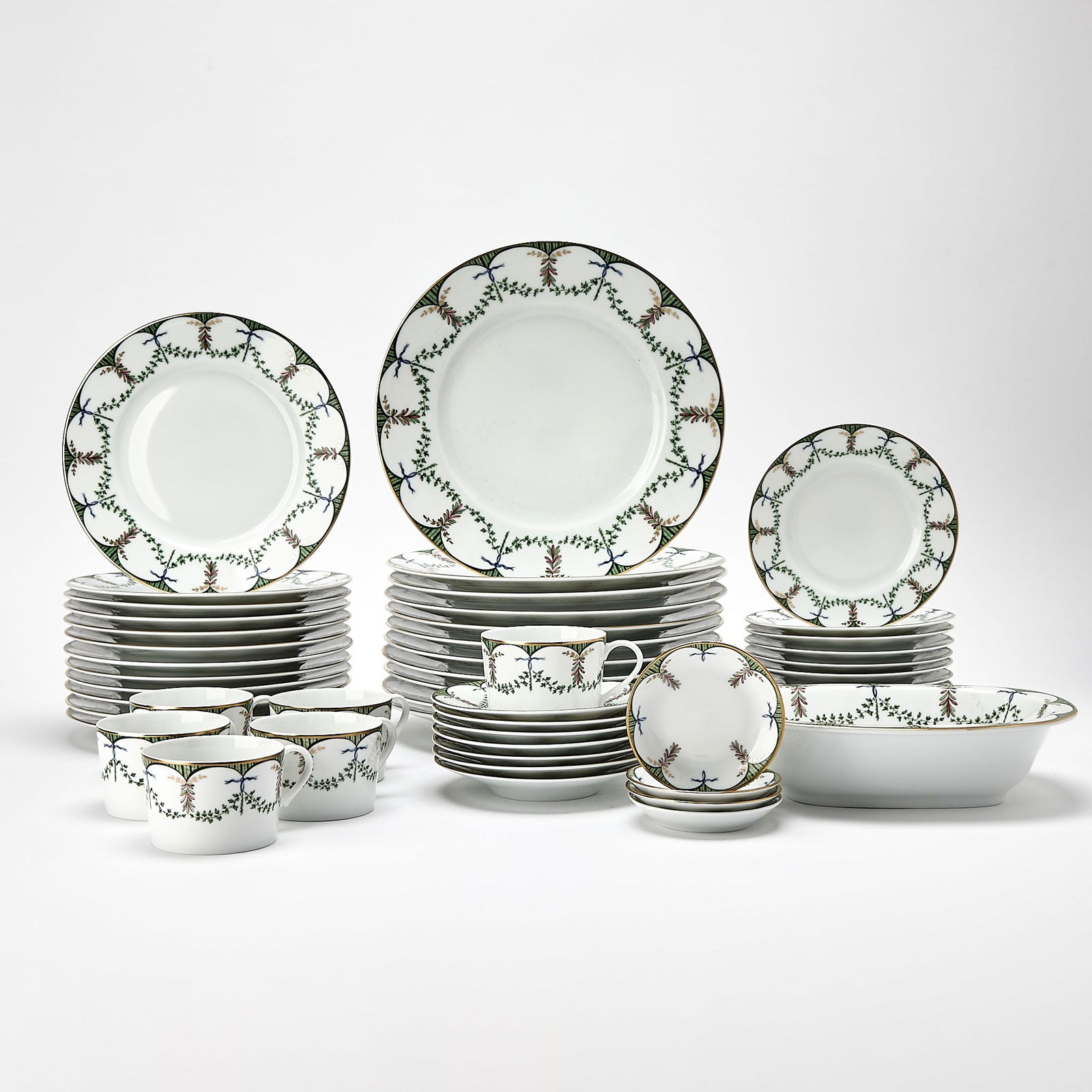 Raynaud & Co. Limoges Porcelain Festivities Pattern Table Service: Comprising: Eleven dinner plates, diameter 10 3/4 inches Twelve salad/dessert plates, diameter 8 3/4 inches Eleven bread and butter plates Six teacups Seven saucers Four butter pats Servi