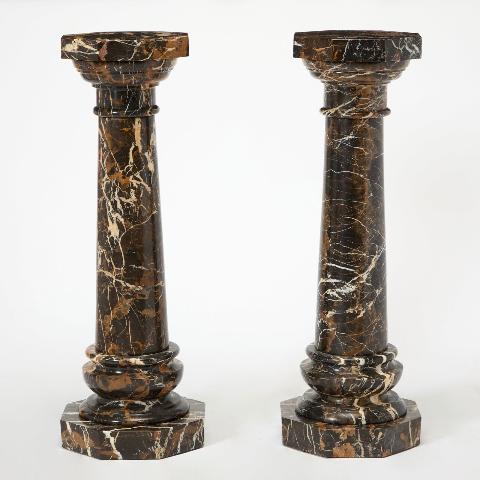 Pair of Marble Pedestals: Height 43 3/4 inches, diameter of top 14 inches.