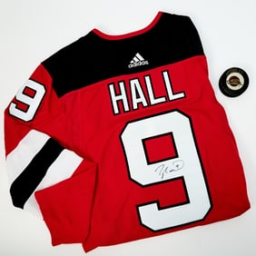 NJ Devils Jersey signed by Taylor Hall, a puck signed by Pavel Bure, and two framed photographs