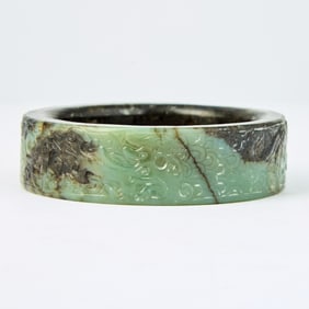 A Chinese Archaistic Mottled Jade Bangle