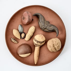 A Chinese Yixing Pottery Circular Tray with Nuts and Seeds Signed Zhongguo Yixing, 1970s-80s