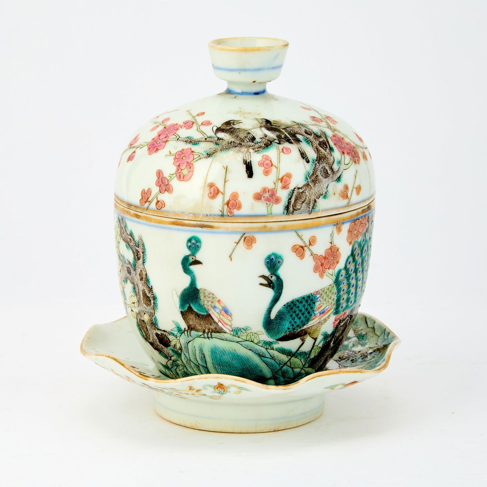 A Chinese Enameled Porcelain Rice Bowl, Saucer and Cover Guangxu Mark, Late Qing-Republic Period: The deep bowl, stand and cover all decorated in rose enamels to show peacocks and songbirds among flowering prunus and plum boughs. (Height 5 1/2 inches)