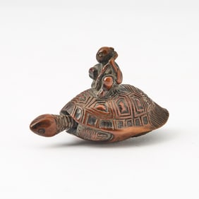 A Japanese Boxwood Netsuke showing a Tortoise Supporting a Man Edo Period