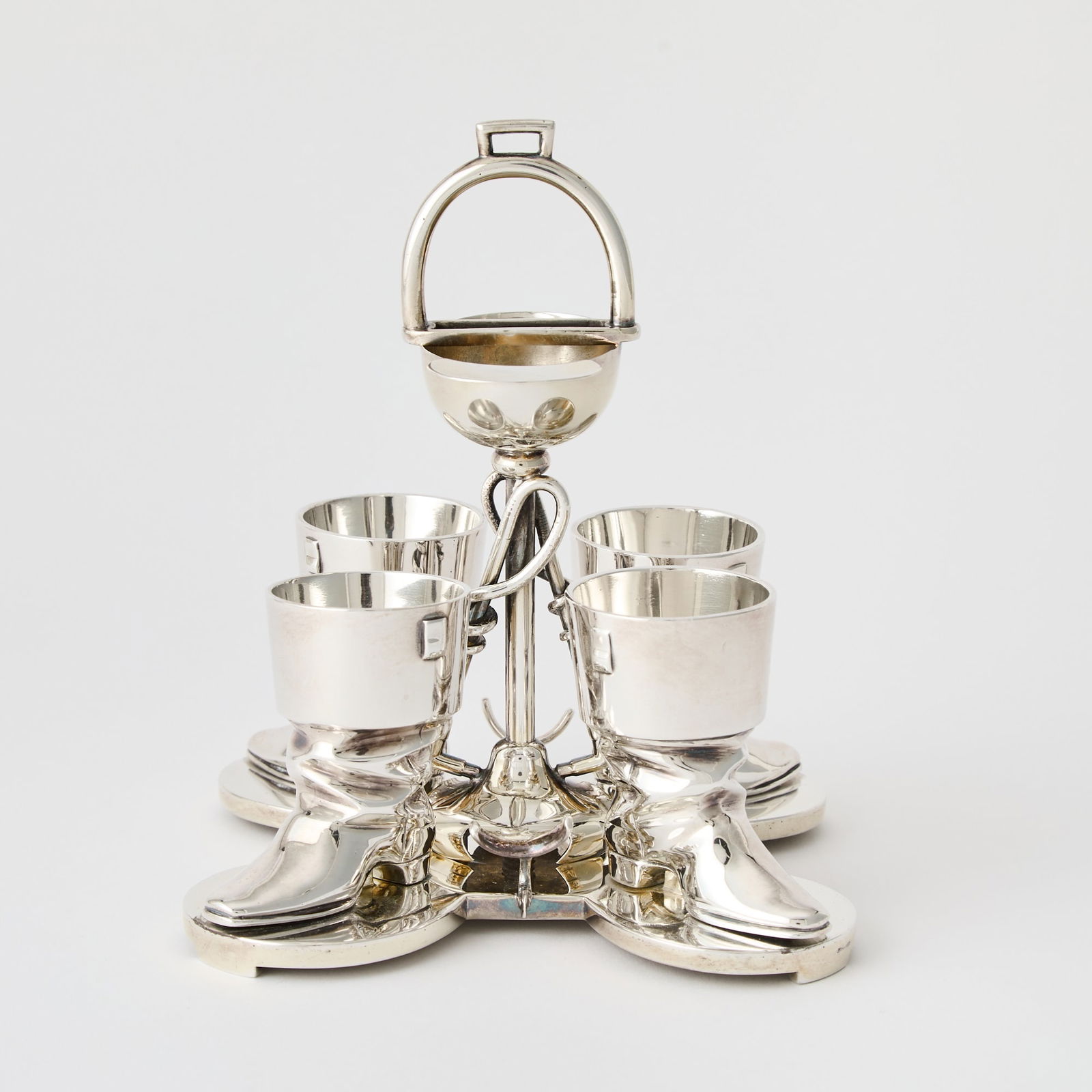 Equestrian Interest: Novelty Silver Plated Egg Cruet: Late 19th/early 20th century The frame with riding crops and helmet, with four boot-form egg cups. Height overall 7 inches.