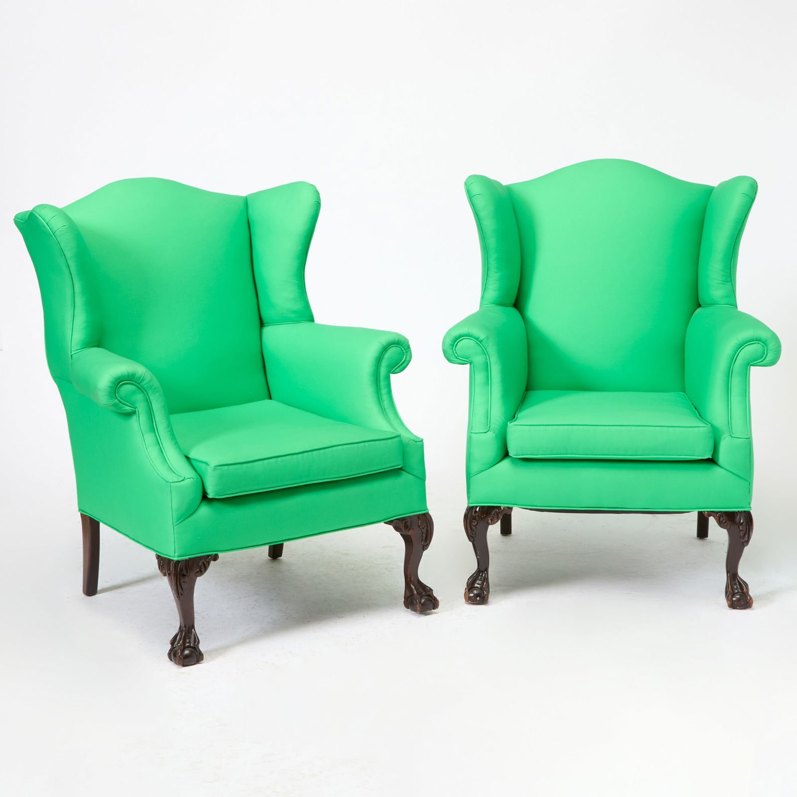 Pair of George III Style Upholstered Mahogany Wing Chairs: Mid-20th Century Height 40 inches, width 33 inches, depth 25 inches. upholstery in good condition, distressed finish, one foot tip missing