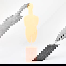 Greek Cycladic Marble Idol: Early Bronze Age II, circa 2600-2400 B.C. Depicted with her arms folded across waist, oval shape head leaning back, with elongated neck, sloping shoulders and flaring head with long aquiline nose, the