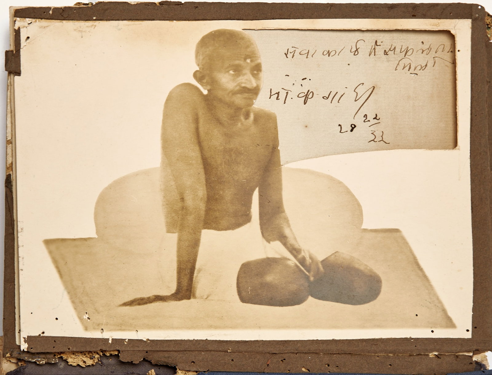 An early photograph of Gandhi with his signature inset: GANDHI, MAHATMA An album containing an early photograph of Gandhi with his signature inset, as wel
