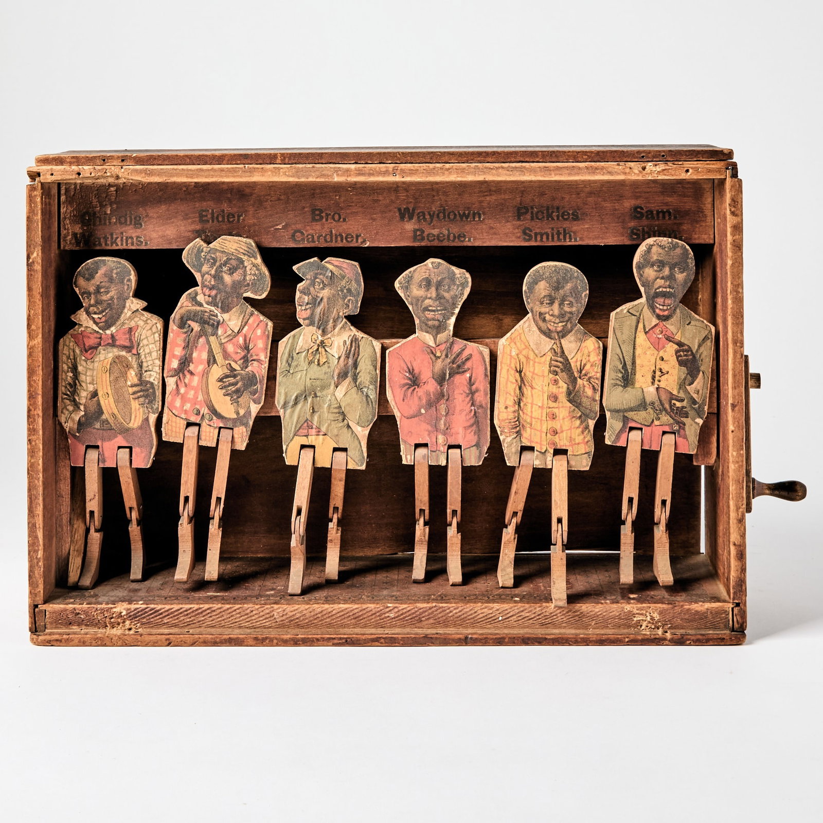 1890s crank toy of dancers on stage: GAMES Old Kentucky Home. Circa 1890s. Original wooden box, chromolithography. 10 x 15 1/4 x 4 1/2 inches (25 x 39 x 11) cm. Wear to box and chromolithography consistent with age. Condition is ov