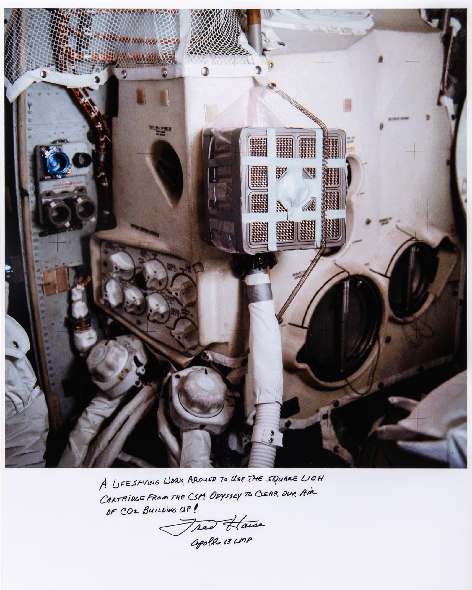 Apollo 13 color photograph inscribed by astronaut Fred Haise: [SPACE-APOLLO 13] Apollo 13 color photograph inscribed by Fred Haise depicting "LIOH Mailbox." A large color printed photograph, 16 x 20 inches (41 x 51 cm), inscribed: "A lifesaving work around to us