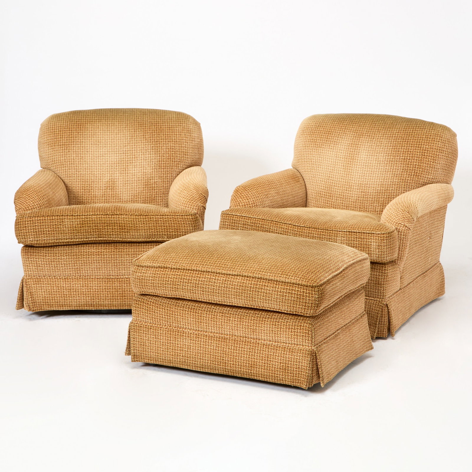 Pair of Upholstered Swivel Club Chairs and Ottoman: Height 33 inches, width 34 inches, depth of seat 24 inches, height of seat 19 inches. no known maker; ottoman on wheels; foam cushions; a small hole to side of one chair; wear to head rests