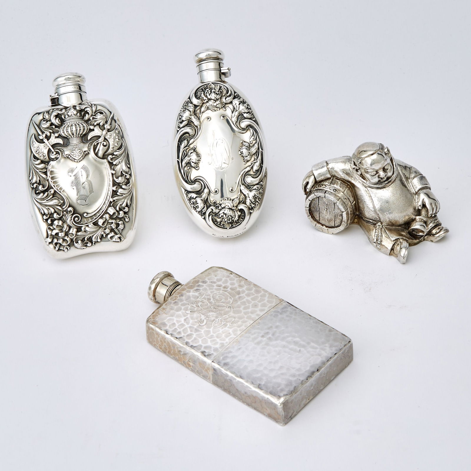 Three Sterling Silver Pocket Flasks: Inlcuding an example by Tiffany & Co.; Together with an Italian 800 Quality Silver Figure of a Drunken Friar with a Wine Keg. Inscribed A. de Luca. Height 2 7/8 inches. Total approximately