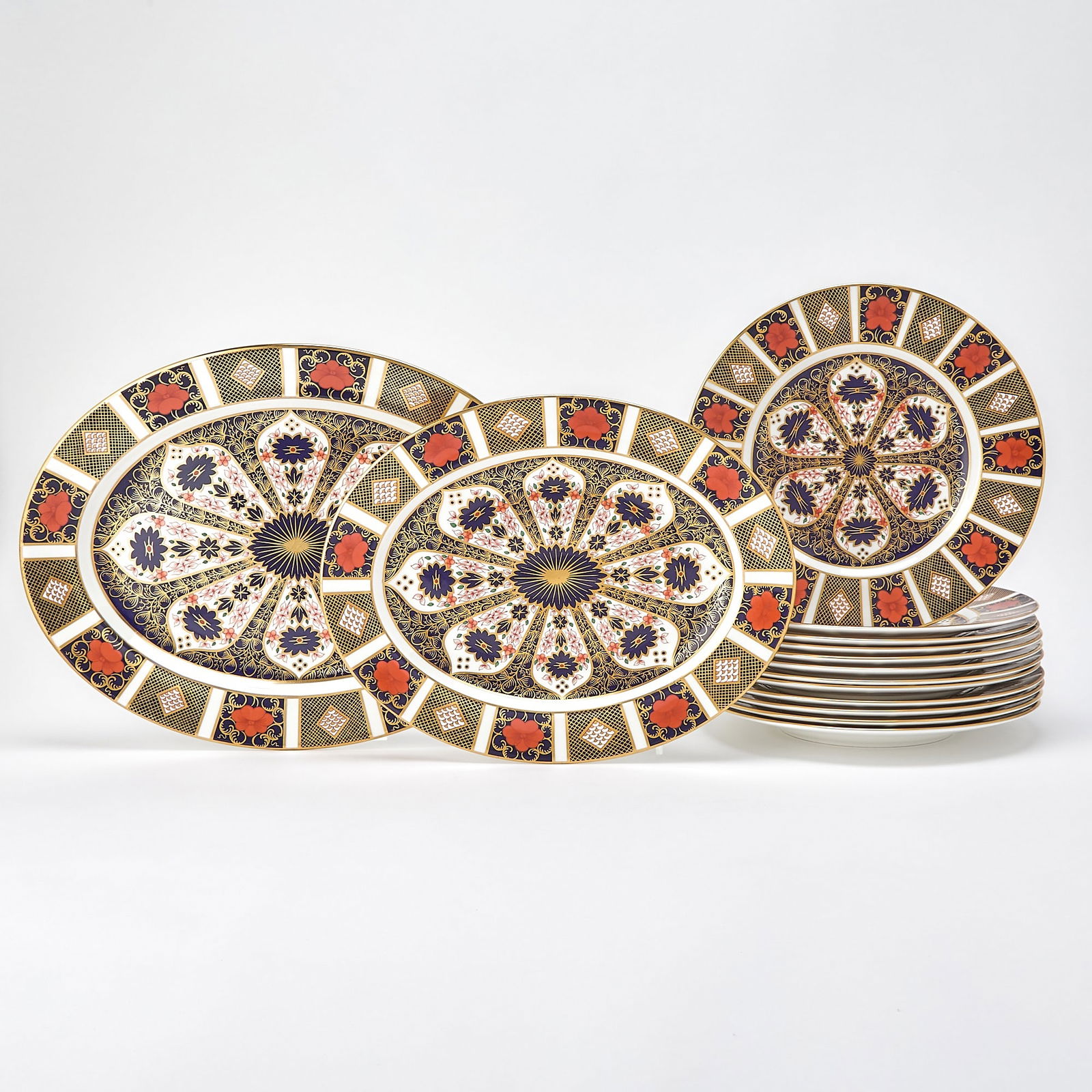 Royal Crown Derby Porcelain Old Imari Pattern Part Dinner Service: Comprising: Two platters, length of largest 16 1/4 inches Twelve dinner plates, diameter 10 3/4 inches