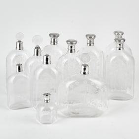 Group of Eleven Etched Glass and Silver Decanters