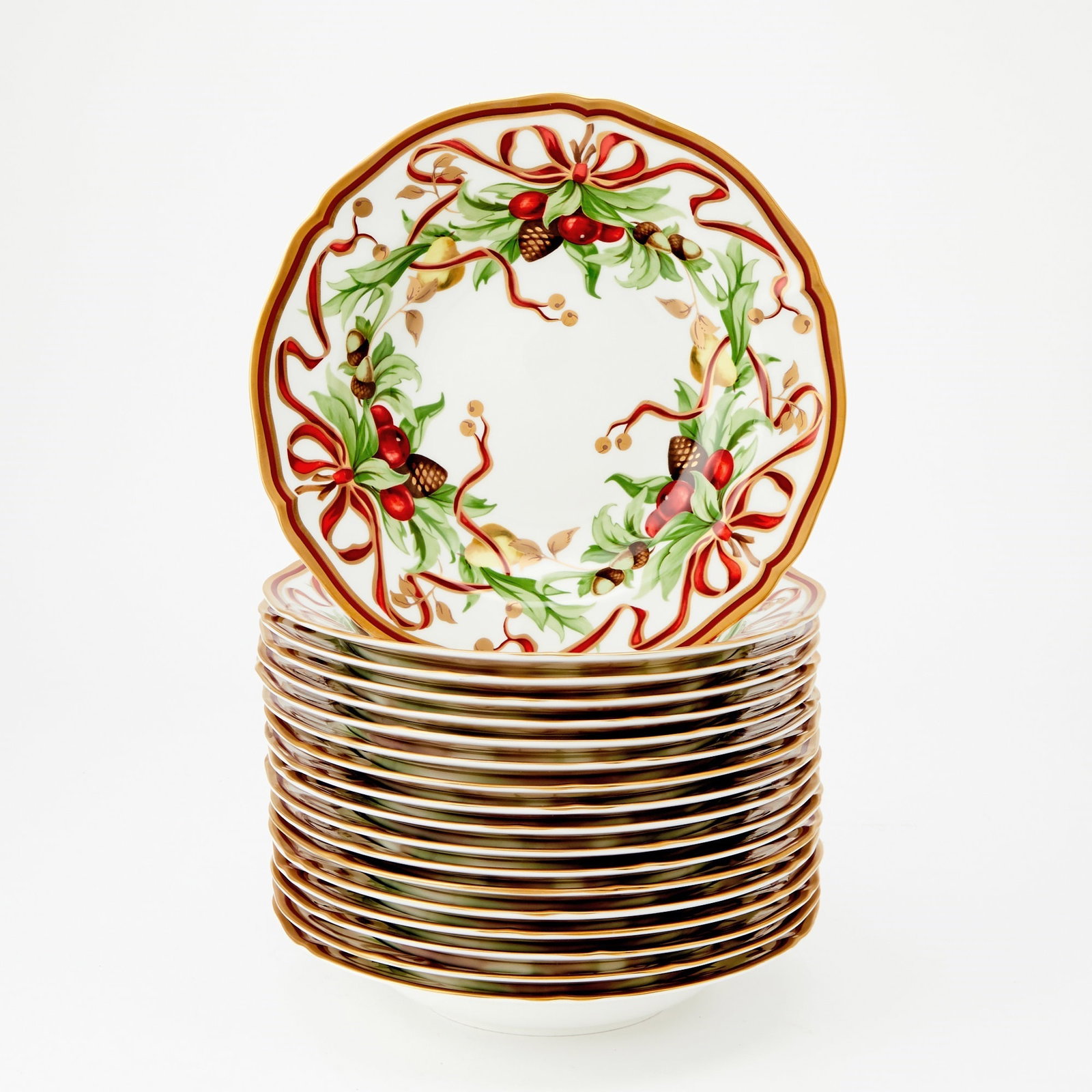 Eighteen Porcelain 'Tiffany Holiday' Garlanded Soup Plates 20th century, made in Japan for Tiffany &: Each decorated with three red ribbon-tied holiday sprays of pinecones, berries, acorns and pears, within a shaped red and gilt line rim, diameter 9 inches (18). each bowl a