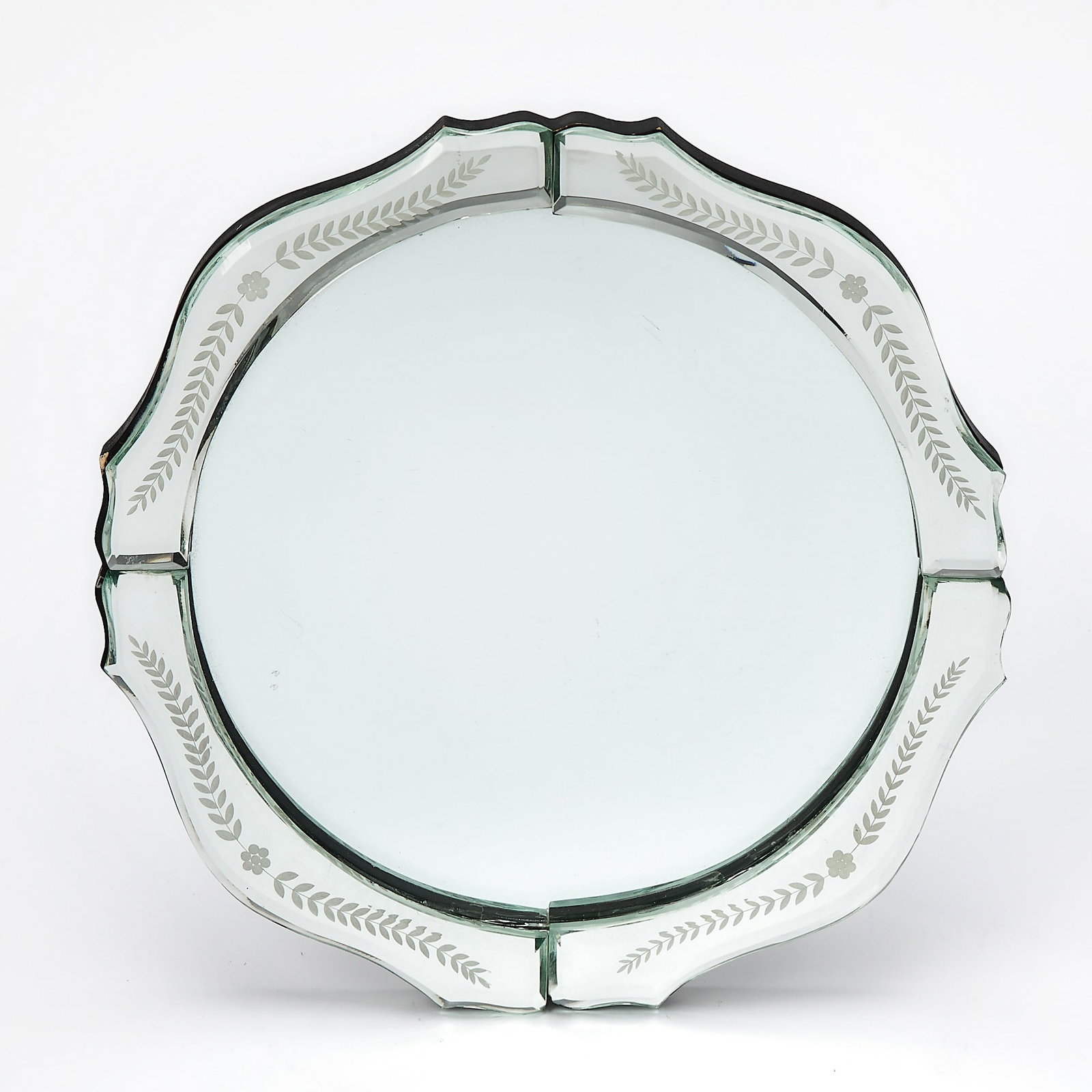 Mirrored Plateau: Of shaped circular form, with a beveled edge. Diamerer 12 inches. There are scratches to the center mirror plate; there are some scattered small nick losses and abrasions to the wood base.