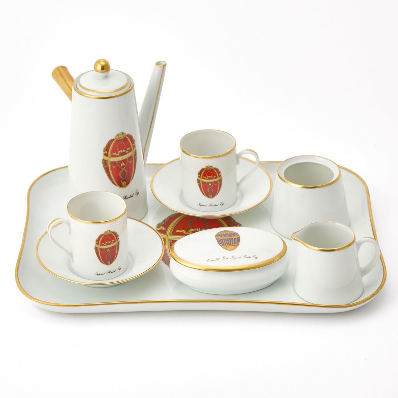 Fabergé for Limoges Porcelain Demitasse Set: Comprising a tray, length 12 inches; two demitasse cups; two demitasse saucers; covered box; sugar bowl; cream jug; and espresso pot, height 5 1/2 inches. sugar bowl lacking cover; otherwise, general