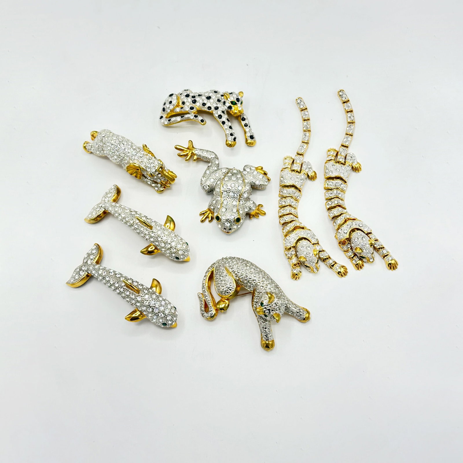 Group of Oversized Whimsical Animal Rhinestone Brooches: Including two dolphins, a leaping elephant, two cats, two reticulated cats, and a frog. Length of dolphins 4 inches.