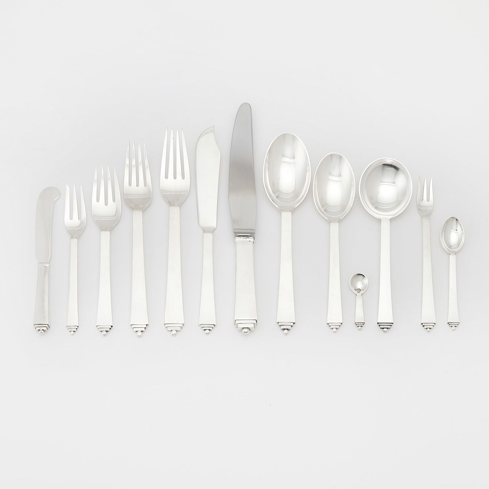 Assembled Georg Jensen Sterling Silver "Pyramid" Pattern Flatware Service: 20th Century (various date marks) Comprising: Eight cocktail forks, length 5 7/8 inchesTen four-tine forks, length 7 1/8 inchesTwelve four-tine forks, length 6 1/8 inches Seven dinner forks,