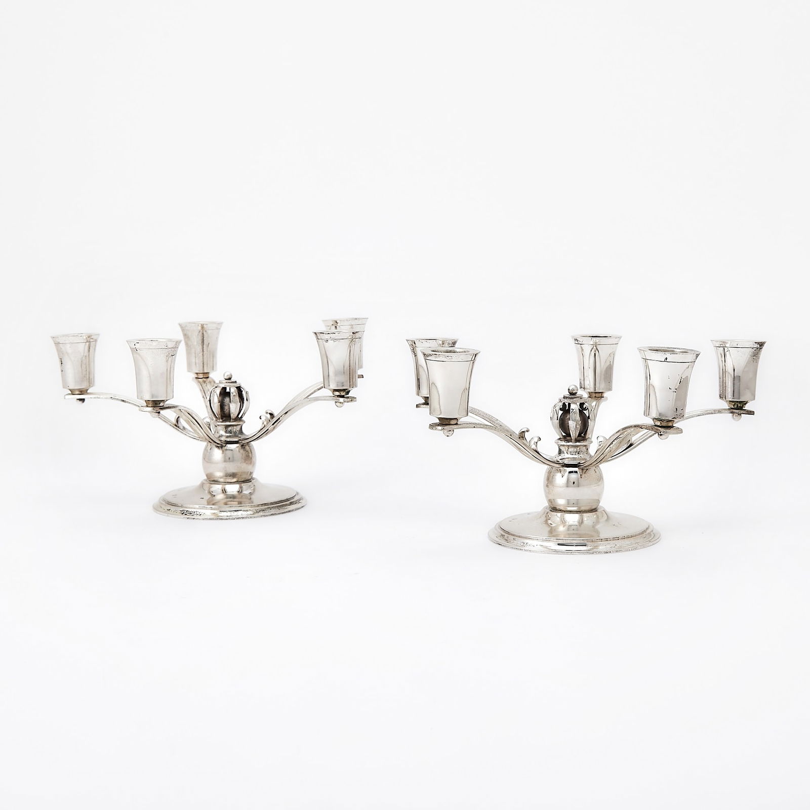 Pair of Danish Sterling Silver Five-Light Candelabra: Anton Michelsen, Copenhagen, 20th century On circular foot, with openwork ball finial. Height 5 1/2 inches, diameter 9 inches, weighted.