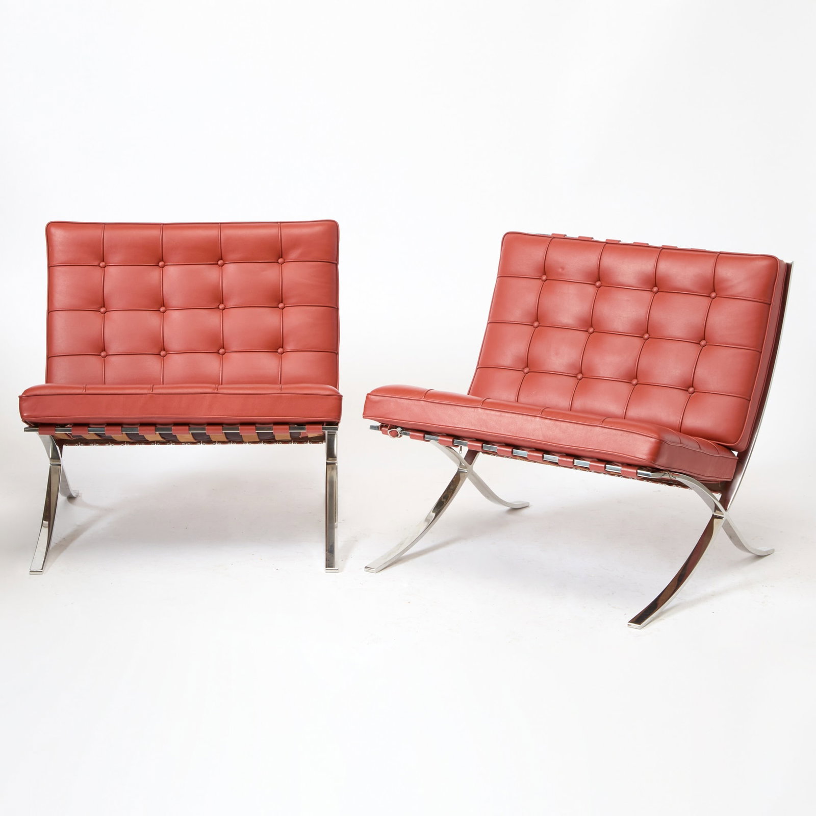 Pair of Mies van der Rohe Chromed Metal and Leather Upholstered "Barcelona" Lounge Chairs: For Knoll Studio, late 20th century Height of back 28 inches, height of seat 18 inches, width 29 1/4 inches, depth 32 inches.