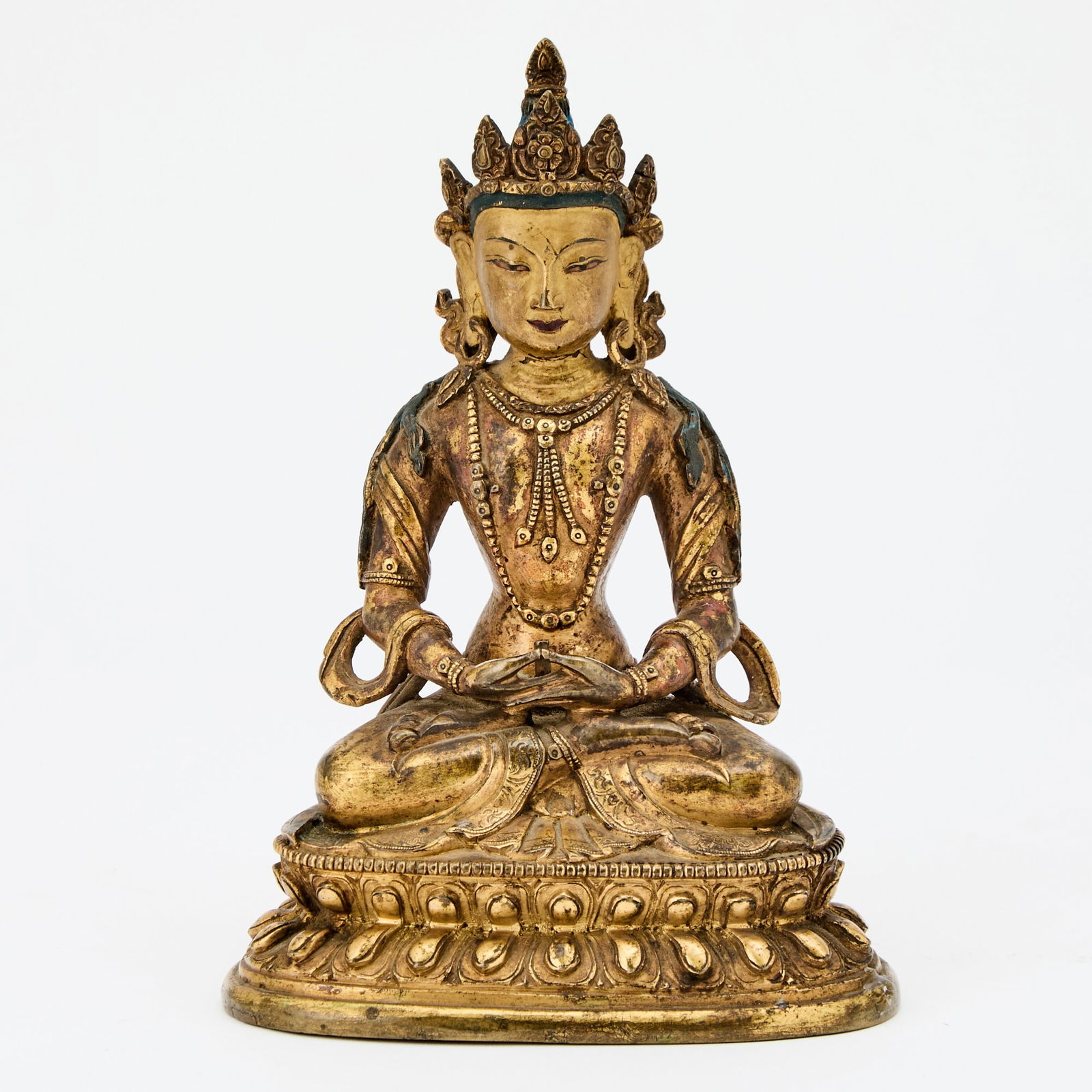 Sino-Tibetan Gilt Bronze Figure of Amitayus: 18th Century The seated figure in dhyansana cast atop a double lotus base. Height 7 inches.