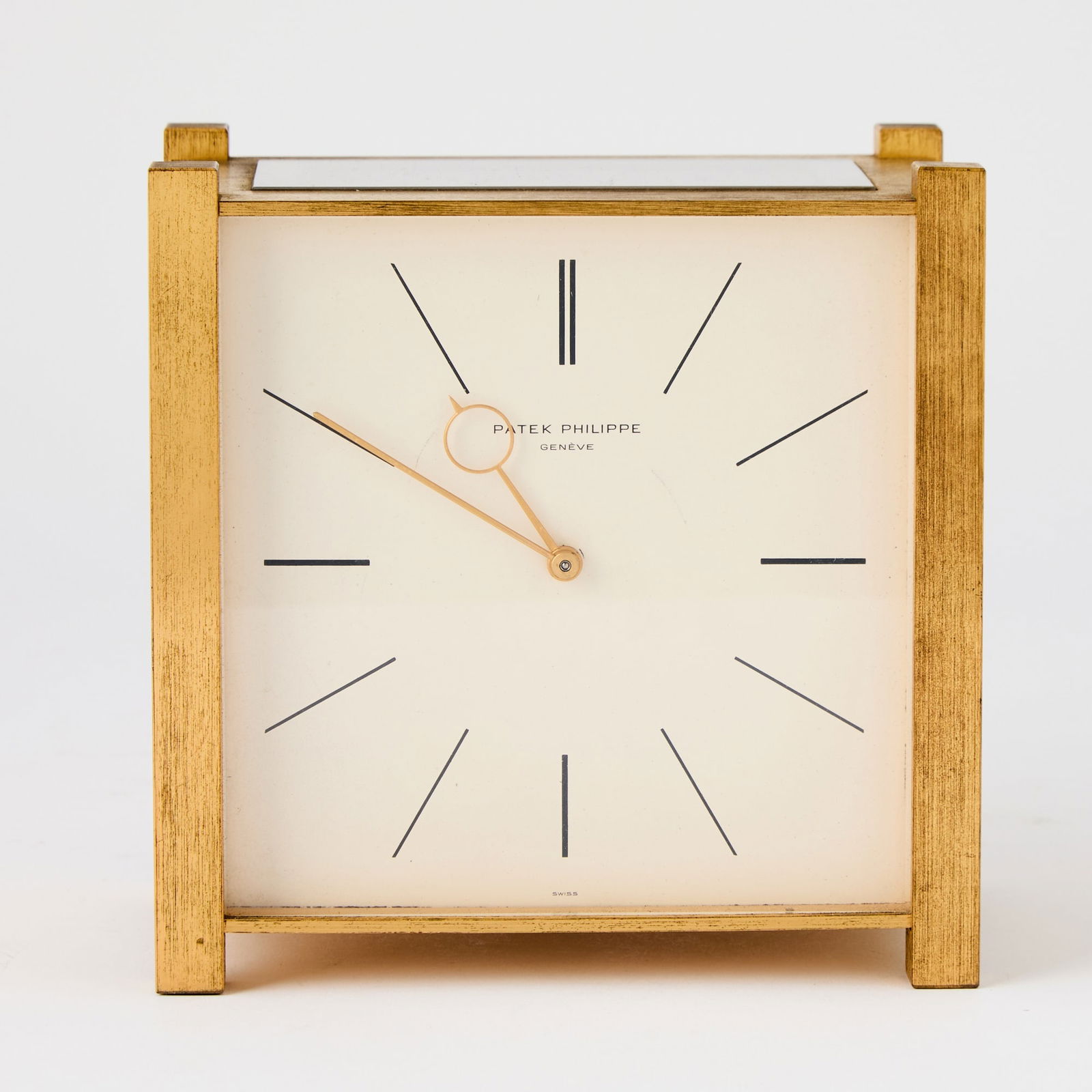 Patek Philippe Brass Solar Desk Clock: Mid 20th century With rectangular solar panel, the white enamel clock face with Roman numerals and signed PATEK PHILIPPE / GENÈVE within a square brass case, the reverse with applied placque insc