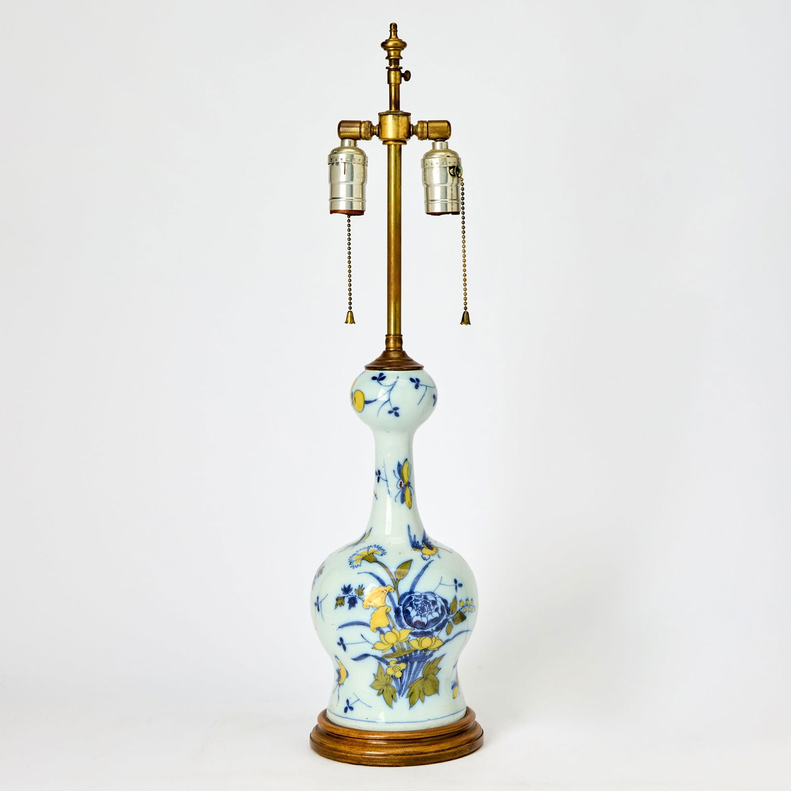 Dutch Delft Faience Vase: 18th century Mounted as a lamp, with chinoiserie decoration of birds and flowers in blue and yellow. Height 12 inches, diameter 6 inches. Drilled; mounted on a wood base; neck reduced in height; glaz