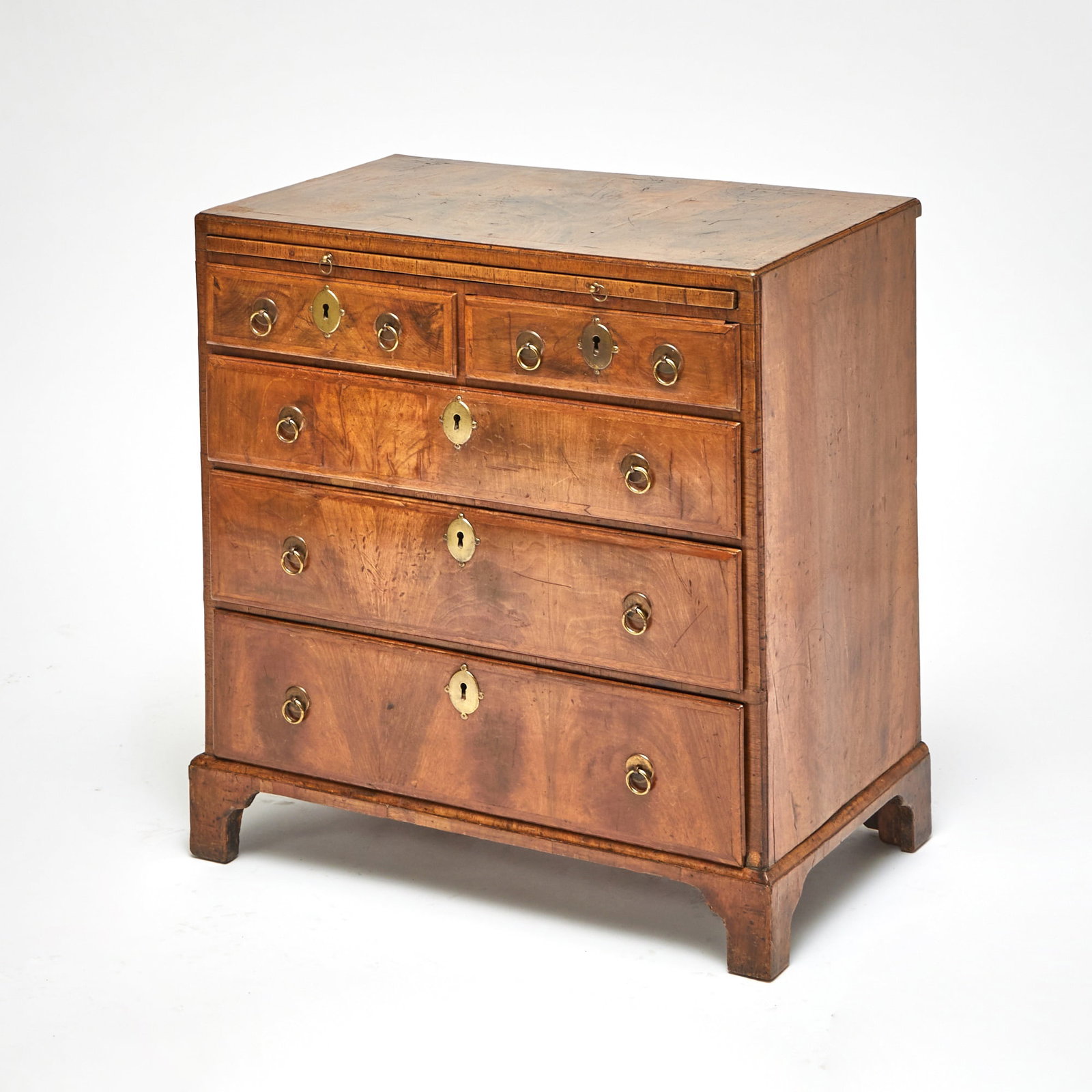 George II Walnut Chest of Drawers: The Jane Stanton Hitchcock Collection Circa 1740 The rectangular top above two short and three long graduated drawers, raised on bracket feet. Height 29 3/4 inches, width 27 3/4 inches, depth 15 3/4 i
