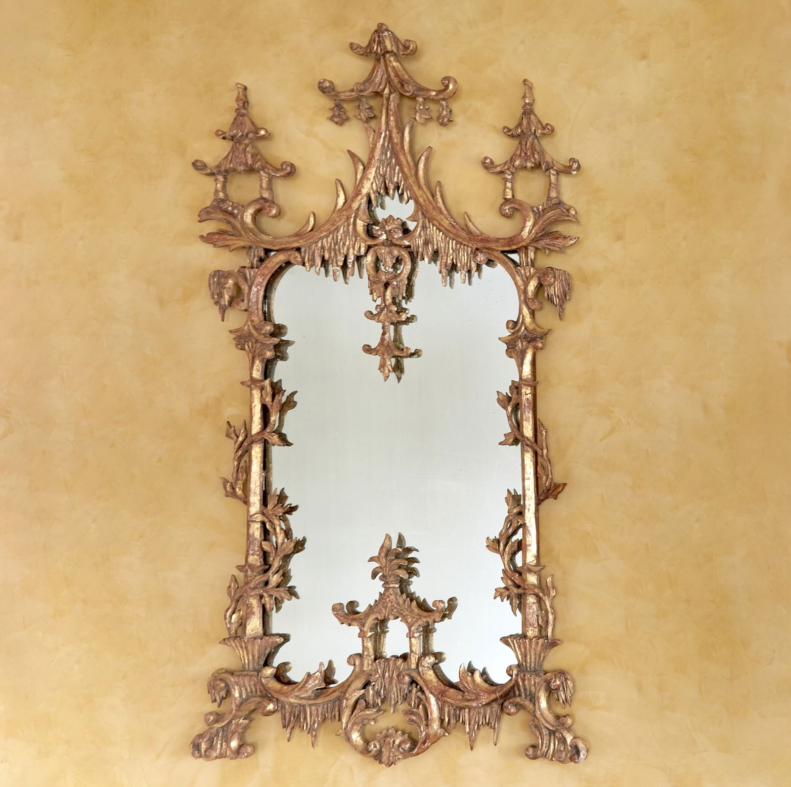 Pair of Irish George III Style Carved Giltwood Mirrors: In the manner of Thomas Chippendale, circa 1880Each shaped mirror plate within a carved giltwood frame, the cresting with icicle drip carvings and rocaille scrolls flanked by pierced latticework suppo