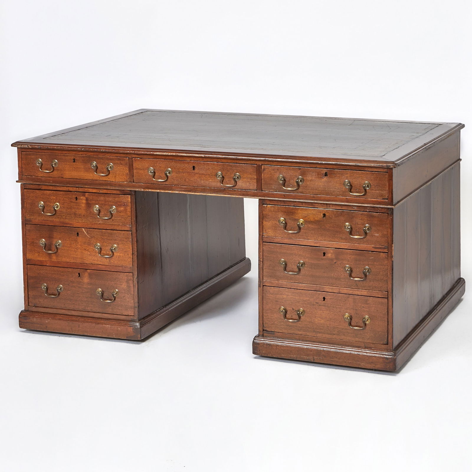 George III Gilt-Tooled Green Leather-Lined Mahogany Pedestal Partner's Desk: Late 18th centuryThe rectangular top above three frieze drawers, supported by a pedestal base, one pedestal fitted with three drawers, the other pedestal fitted with a paneled cupboard door. Height 31