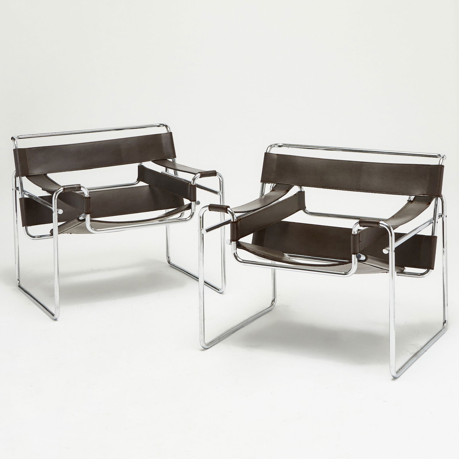 Pair of Marcel Breuer Style Chromed Metal and Leather "Wassily" Chairs: Height 28 inches, width 25 1/2 inches, depth 18 inches. Please note the description for this lot was updated on Monday January 12.