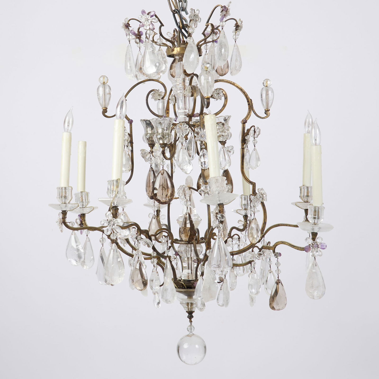 Louis XIV Ormolu and Rock Crystal Eight-Light Chandelier: Probably early 18th century The cage issuing eight shaped and scrolling branches hung with droplets, terminating in hexagonal drip-pans and conforming nozzles, with sphere finial. Height 37 inches (93